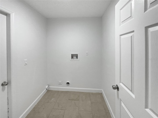 laundry area featuring laundry area, baseboards, a textured ceiling, washer hookup, and electric dryer hookup