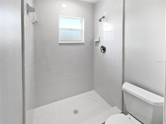 full bath with a stall shower and toilet