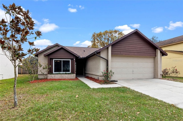 view of front of property featuring a garage, driveway, and a front lawn