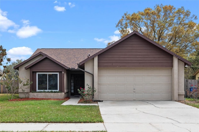 view of front facade featuring a garage, concrete driveway, a front lawn, and roof with shingles