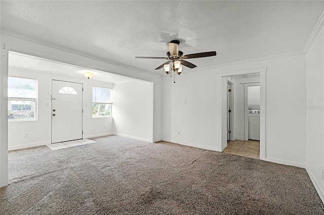 interior space with a textured ceiling, ornamental molding, carpet, and a ceiling fan