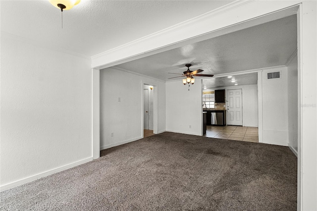 1622 Dolphin Dr, Saint Cloud, FL 34771 - unfurnished living room with visible vents, ceiling fan, crown molding, a textured ceiling, and carpet flooring