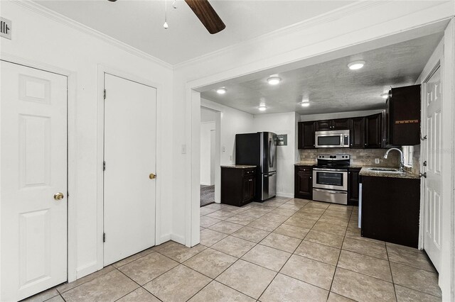 1622 Dolphin Dr, Saint Cloud, FL 34771 - kitchen featuring light tile patterned floors, stainless steel appliances, a sink, ornamental molding, and decorative backsplash