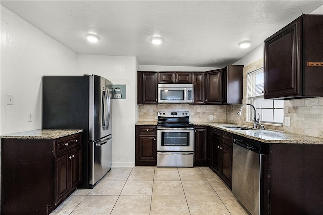 1622 Dolphin Dr, Saint Cloud, FL 34771 - kitchen with stainless steel appliances, light tile patterned flooring, a sink, and decorative backsplash