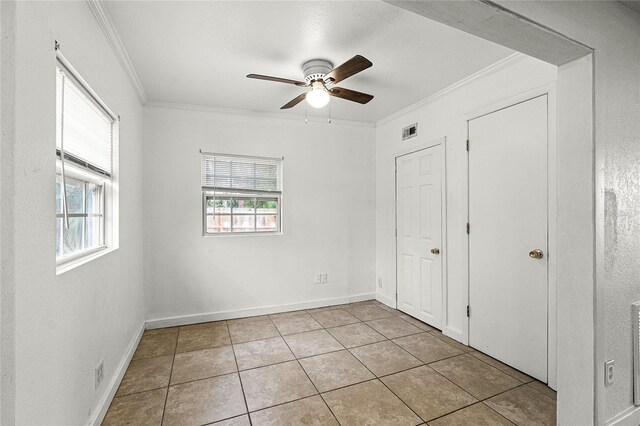 1622 Dolphin Dr, Saint Cloud, FL 34771 - unfurnished bedroom featuring visible vents, crown molding, baseboards, and tile patterned floors
