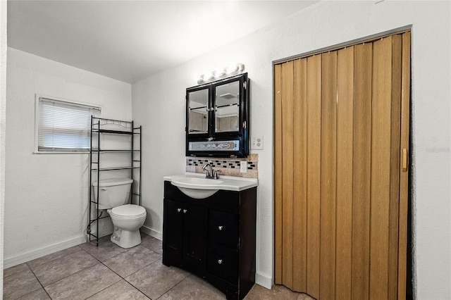 1622 Dolphin Dr, Saint Cloud, FL 34771 - bathroom with baseboards, toilet, tile patterned flooring, vanity, and backsplash