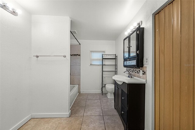 1622 Dolphin Dr, Saint Cloud, FL 34771 - bathroom featuring baseboards, bathing tub / shower combination, toilet, tile patterned floors, and vanity