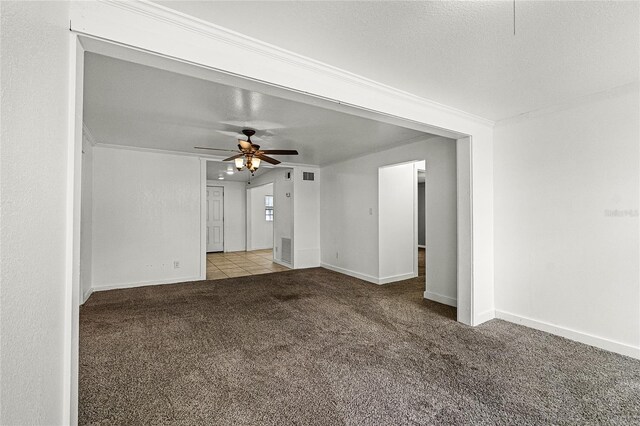 1622 Dolphin Dr, Saint Cloud, FL 34771 - carpeted spare room featuring visible vents, ornamental molding, ceiling fan, a textured ceiling, and baseboards
