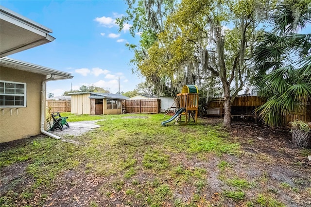 1622 Dolphin Dr, Saint Cloud, FL 34771 - view of yard with a fenced backyard, a playground, and an outbuilding