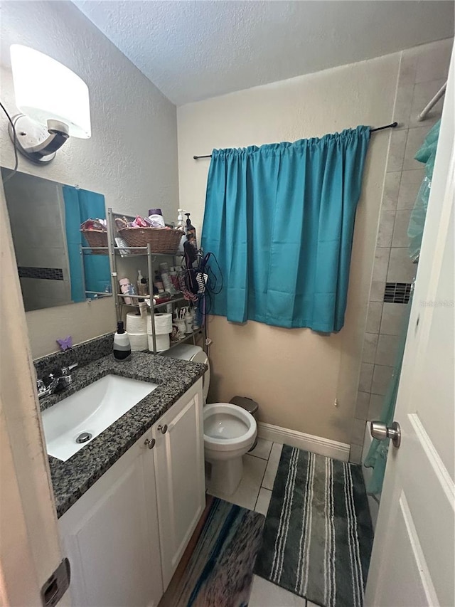 full bathroom with a textured wall, toilet, vanity, a textured ceiling, and baseboards