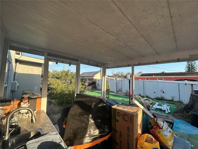 exterior space featuring a fenced backyard and a sink