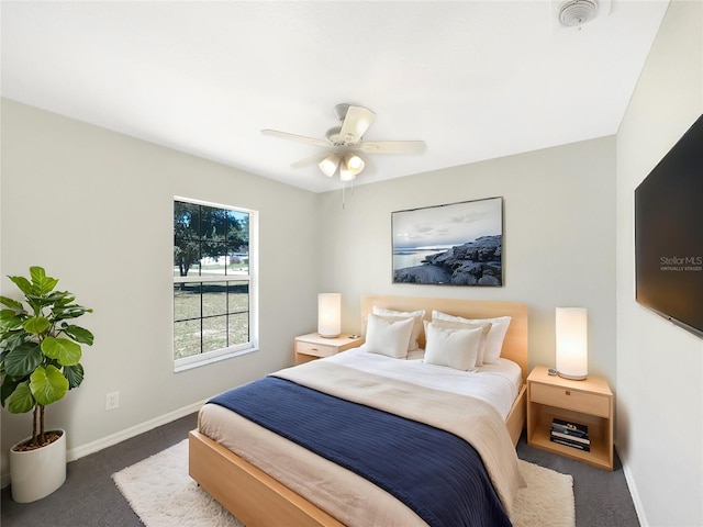 bedroom with dark carpet, baseboards, and ceiling fan