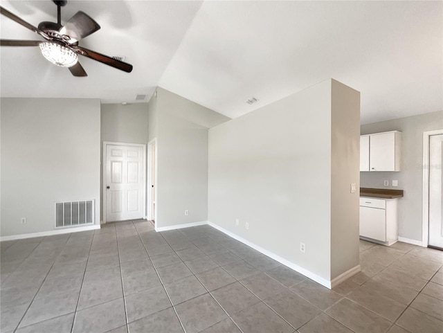 unfurnished room with ceiling fan, baseboards, visible vents, and vaulted ceiling