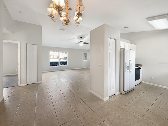 kitchen featuring visible vents, range with electric cooktop, white cabinets, open floor plan, and white fridge with ice dispenser