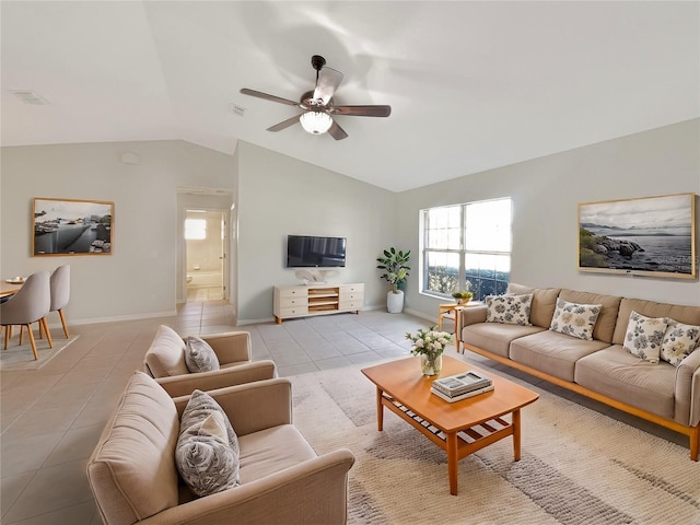 living room featuring lofted ceiling, light tile patterned flooring, a ceiling fan, and baseboards