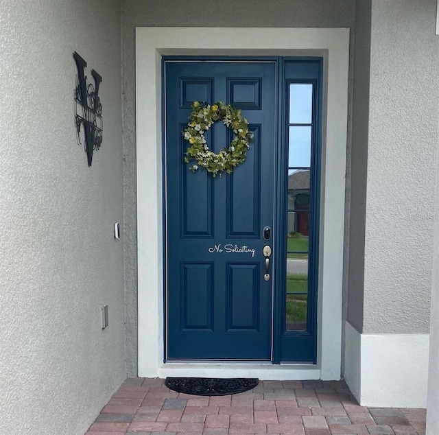 doorway to property with stucco siding