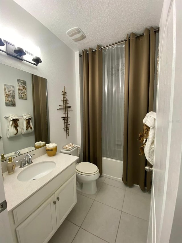 bathroom featuring shower / bath combo, toilet, tile patterned flooring, a textured ceiling, and vanity