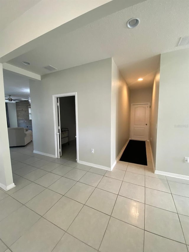 spare room with visible vents, baseboards, light tile patterned flooring, a textured ceiling, and recessed lighting