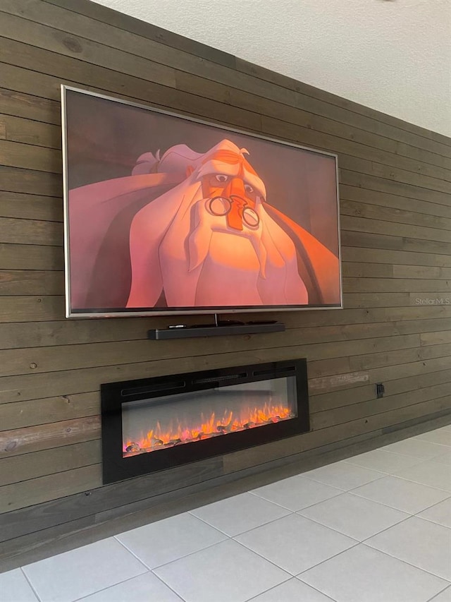 details featuring a glass covered fireplace and wooden walls