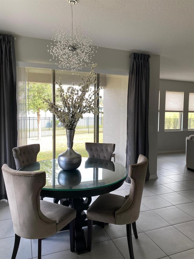 dining area featuring a textured ceiling and light tile patterned flooring