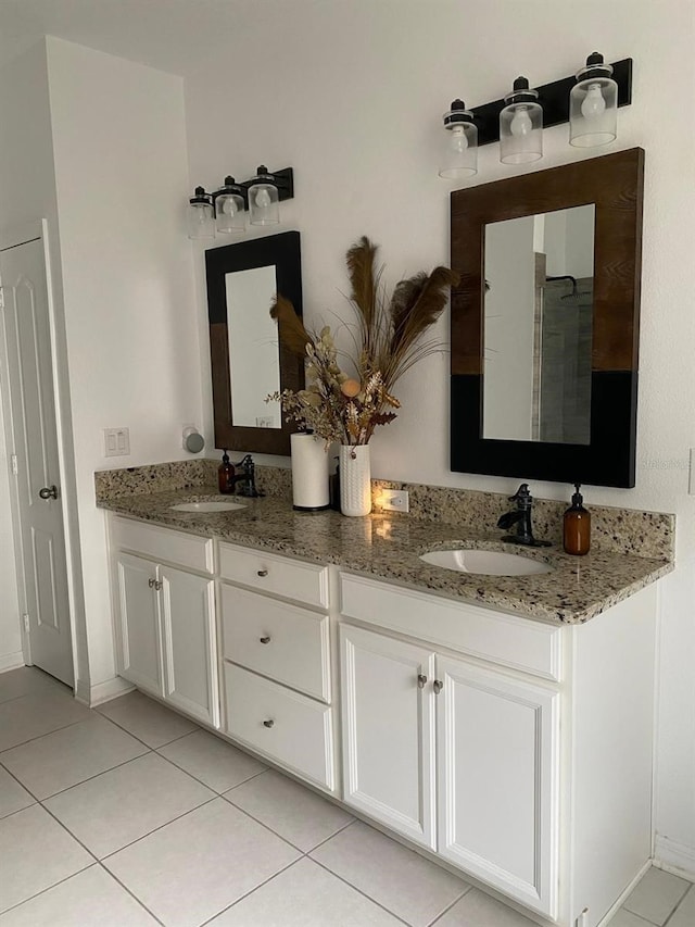 bathroom featuring double vanity, tile patterned flooring, and a sink