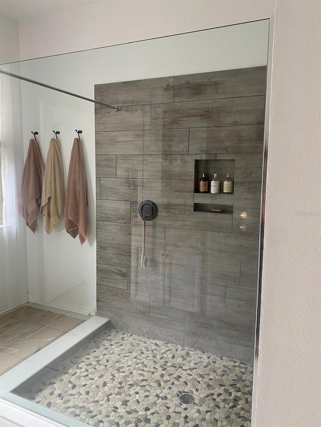 full bath featuring a tile shower