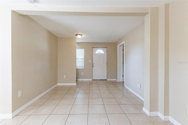 entrance foyer featuring light tile patterned floors and baseboards