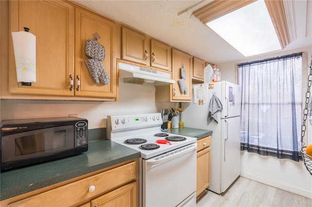 kitchen featuring light wood-type flooring, dark countertops, white appliances, and under cabinet range hood