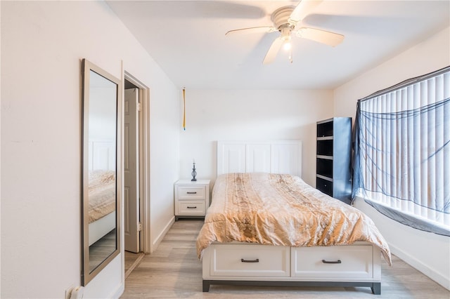 unfurnished bedroom with light wood finished floors, baseboards, and a ceiling fan