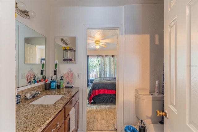 ensuite bathroom featuring a ceiling fan, vanity, toilet, and ensuite bathroom