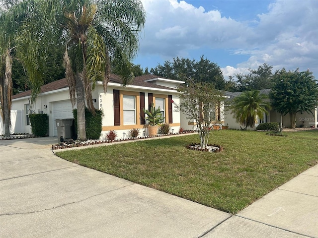 ranch-style home featuring concrete driveway, an attached garage, a front yard, and stucco siding