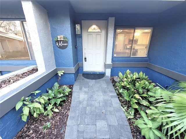 property entrance featuring stucco siding