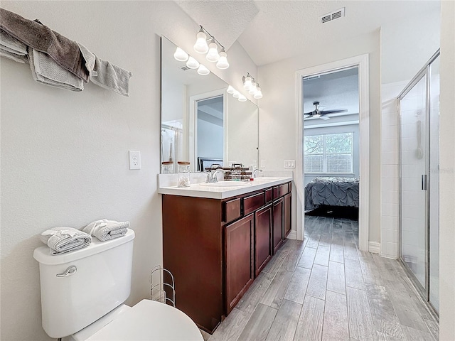 bathroom featuring visible vents, ensuite bathroom, wood tiled floor, a textured ceiling, and a sink