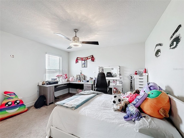 bedroom featuring light carpet, ceiling fan, and a textured ceiling