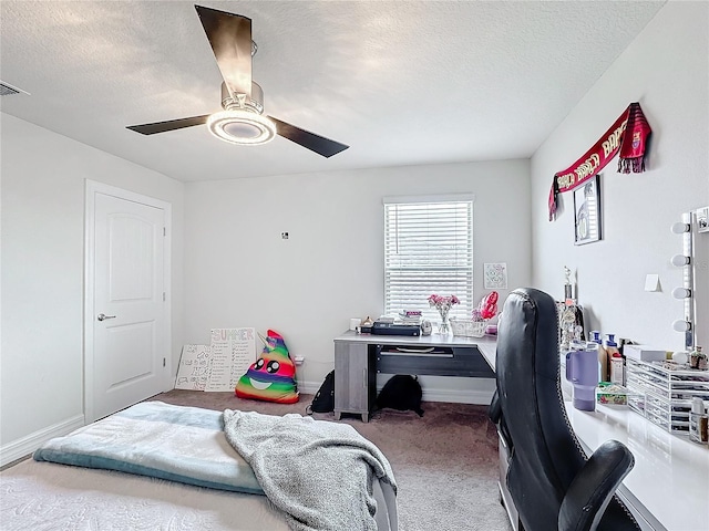 bedroom with carpet floors, a textured ceiling, baseboards, and a ceiling fan