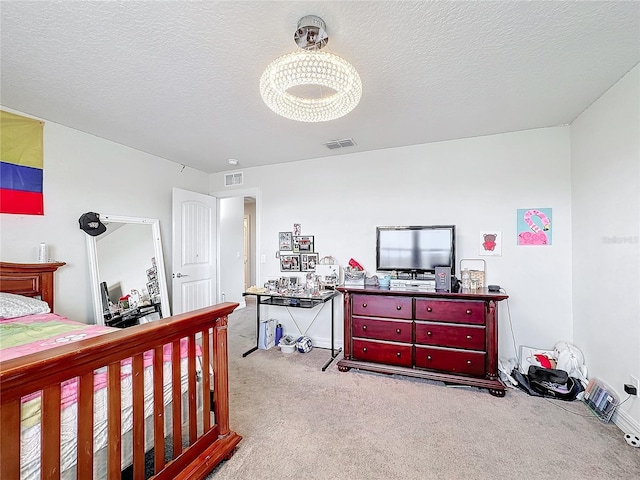 bedroom with light carpet, visible vents, and a textured ceiling