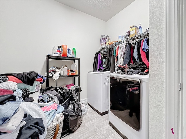 spacious closet featuring light wood finished floors and washer and clothes dryer