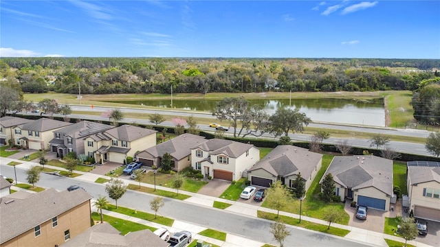 drone / aerial view featuring a residential view and a water view