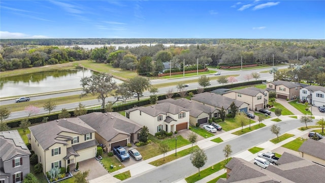 drone / aerial view featuring a residential view and a water view