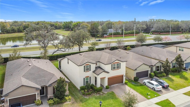 birds eye view of property with a water view and a residential view