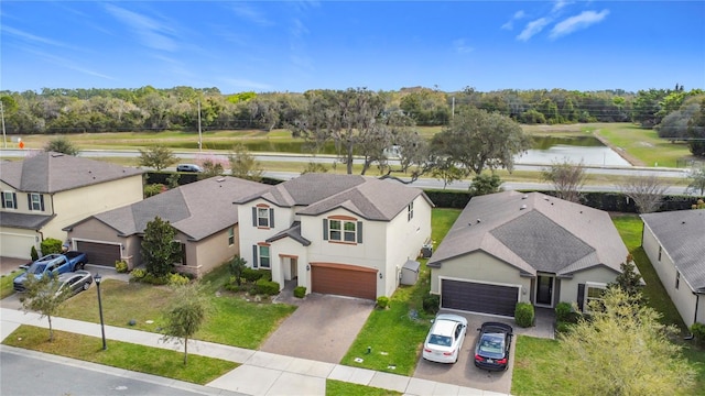 birds eye view of property with a residential view and a water view