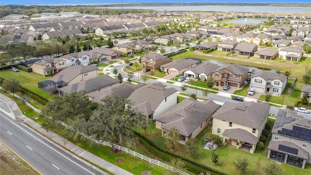 bird's eye view featuring a water view and a residential view