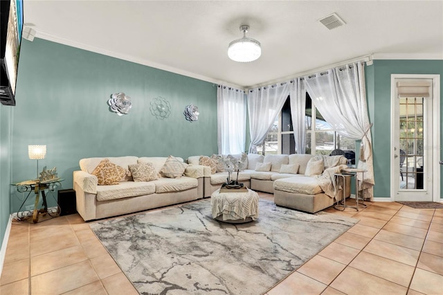 living area featuring light tile patterned floors, baseboards, visible vents, and crown molding