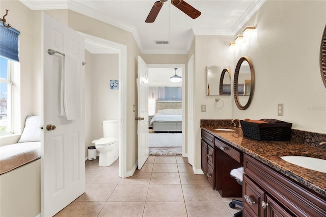 ensuite bathroom with toilet, visible vents, a sink, and ensuite bath