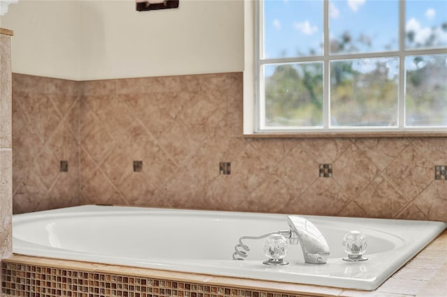 bathroom with tile walls and a bath