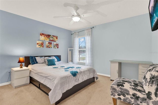 bedroom featuring light carpet, ceiling fan, and baseboards