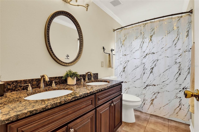 full bath featuring toilet, double vanity, a sink, and visible vents