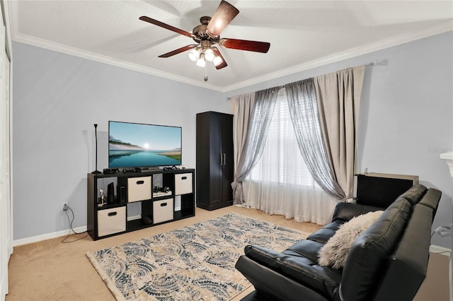 living area featuring light carpet, ornamental molding, a ceiling fan, and baseboards