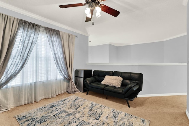 sitting room featuring a ceiling fan, baseboards, ornamental molding, and carpet flooring
