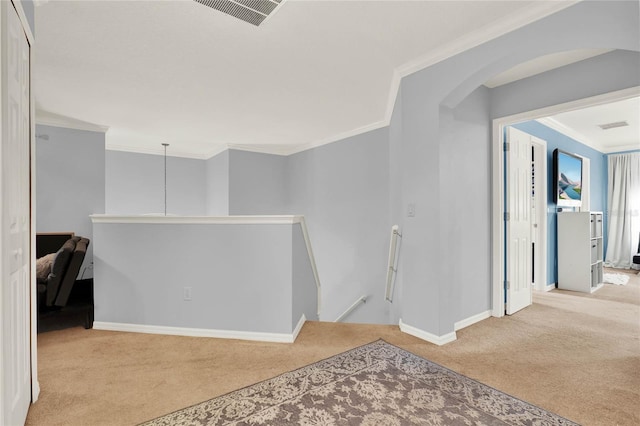 hallway with baseboards, visible vents, light colored carpet, ornamental molding, and an upstairs landing